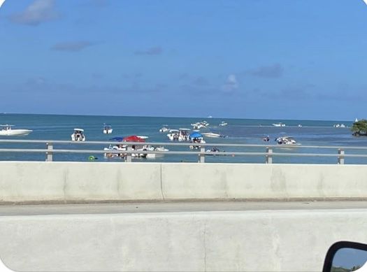 Party scene off the Bear Cut Bridge on Sat